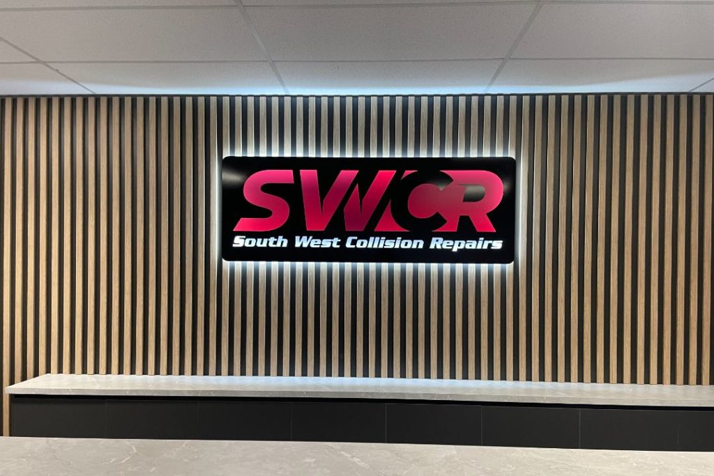 South West Collision Repairs signage on a modern, slatted wall.