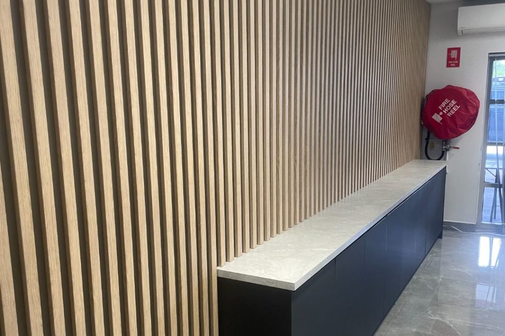 Modern interior with slatted wall and counter at South West Collision Repair Centre.