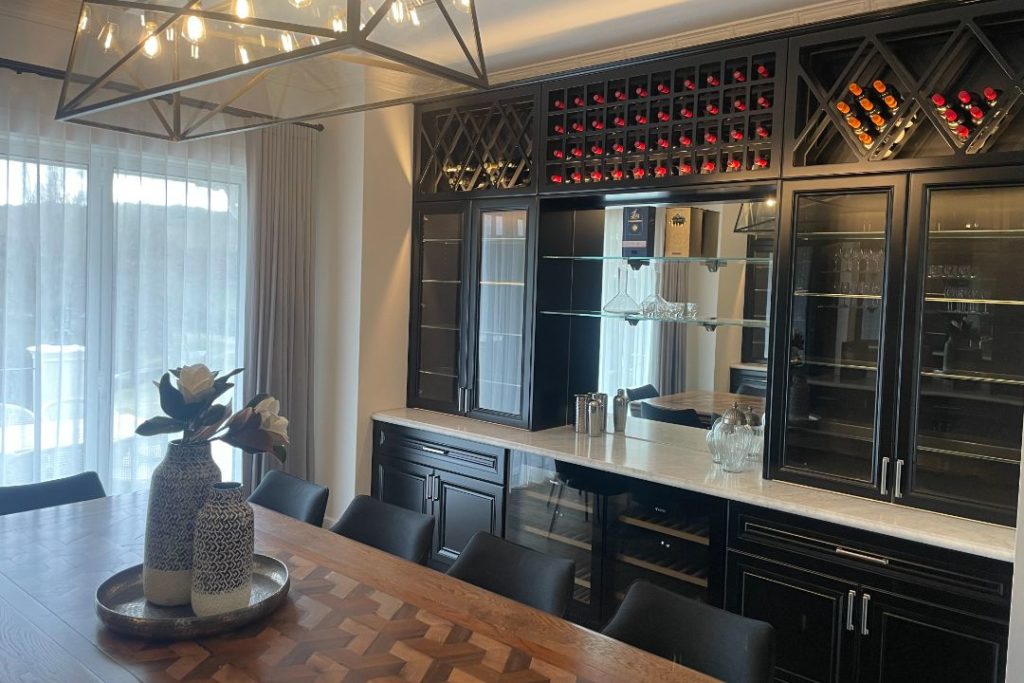 Elegant dining area with a custom-built wine rack and cabinetry.