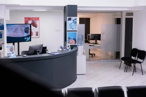 Modern reception area in a professional setting featuring sleek joinery work, including a curved desk and minimalistic design elements, tailored for financial institutions in Sydney. The space exudes a clean and premium aesthetic.